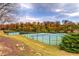 Multiple tennis courts with fall foliage in background at 419 Murphy Ave, Canton, GA 30114