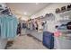 Spacious walk-in closet featuring a carpet floor and an organized storage system with shelves and rods at 419 Murphy Ave, Canton, GA 30114