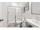 Bathroom features a glass shower, white vanity, and modern decor at 216 Wilder Ridge Way, Lawrenceville, GA 30044