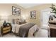 Bedroom with neutral decor, featuring a bed, nightstands and access to a patio at 216 Wilder Ridge Way, Lawrenceville, GA 30044