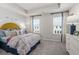 Spacious bedroom with yellow headboard and floral bedding at 216 Wilder Ridge Way, Lawrenceville, GA 30044