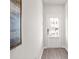 Bright entryway with white door, wood-look flooring, and large wall art at 216 Wilder Ridge Way, Lawrenceville, GA 30044