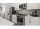 Stainless steel appliances and white shaker cabinets in this kitchen at 216 Wilder Ridge Way, Lawrenceville, GA 30044