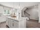 Large kitchen island with seating and modern pendant lighting at 216 Wilder Ridge Way, Lawrenceville, GA 30044