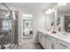 Main bathroom with double vanity, walk-in shower, and view of bedroom at 216 Wilder Ridge Way, Lawrenceville, GA 30044