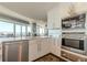 Modern kitchen with stainless steel appliances and white cabinets at 3325 Piedmont Ne Rd # 2904, Atlanta, GA 30305