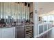 Modern wet bar with granite countertop, wine cooler, and mirrored accent wall at 3325 Piedmont Ne Rd # 2904, Atlanta, GA 30305