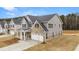 Two-story home with gray siding, brick accents, and a two-car garage at 13958 Conrad Court Ln, Covington, GA 30014