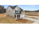 Two-story home with gray siding, brick accents, and a two-car garage at 13958 Conrad Court Ln, Covington, GA 30014