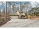 Tan house with a two-car garage and wooden stairs leading to the entrance at 680 Branch Valley Court, Roswell, GA 30076