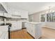 Renovated kitchen with white cabinets, quartz countertops and stainless steel appliances at 680 Branch Valley Ct, Roswell, GA 30076