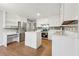 Modern kitchen with white cabinets, quartz countertops and stainless steel appliances at 680 Branch Valley Ct, Roswell, GA 30076
