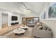 Living room with a stone fireplace, L-shaped sofa and hardwood floors at 680 Branch Valley Ct, Roswell, GA 30076