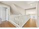 Open upper hallway with white railing and wood-look floors at 680 Branch Valley Ct, Roswell, GA 30076