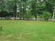 Large backyard with a white fence and lush green grass at 100 Meadow Lake Dr, Carrollton, GA 30116