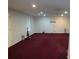 Large finished basement with maroon carpeting, recessed lighting, and plenty of space at 100 Meadow Lake Dr, Carrollton, GA 30116