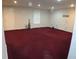 Spacious finished basement with neutral walls and maroon carpeting at 100 Meadow Lake Dr, Carrollton, GA 30116