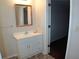 Clean bathroom with white vanity and decorative mirror at 100 Meadow Lake Dr, Carrollton, GA 30116