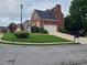 Brick house with a two-car garage and landscaped yard at 100 Meadow Lake Dr, Carrollton, GA 30116
