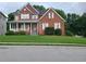 Two-story brick home with a covered porch and manicured lawn at 100 Meadow Lake Dr, Carrollton, GA 30116