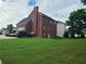 Brick house with a large backyard and green lawn at 100 Meadow Lake Dr, Carrollton, GA 30116