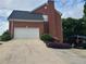 Brick house with a two-car garage and a long driveway at 100 Meadow Lake Dr, Carrollton, GA 30116