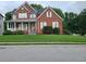 Brick two-story house with a well-maintained lawn at 100 Meadow Lake Dr, Carrollton, GA 30116