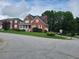 Two story brick home with a front porch and landscaped yard at 100 Meadow Lake Dr, Carrollton, GA 30116
