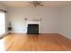 Bright living room featuring hardwood floors and a fireplace at 100 Meadow Lake Dr, Carrollton, GA 30116