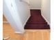 Indoor stairs with burgundy carpet at 100 Meadow Lake Dr, Carrollton, GA 30116
