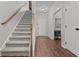 Staircase with gray carpeting and wooden handrail at 4428 Grove Field Park, Suwanee, GA 30024