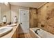 Elegant bathroom with double sinks, soaking tub, and tile flooring at 107 Howard Ne St, Atlanta, GA 30317