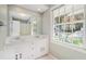 Double sink bathroom with window and built-in vanity at 1883 Acuba Ln, Atlanta, GA 30345