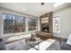 Sunroom with stone fireplace and wall-to-wall windows at 1883 Acuba Ln, Atlanta, GA 30345