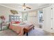 Charming bedroom with a stylish bed, natural light, and a metal headboard at 632 Graymont Dr, Grayson, GA 30017