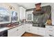 Modern kitchen with white cabinets, copper range hood, and granite countertops at 632 Graymont Dr, Grayson, GA 30017