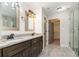 Spa-like bathroom featuring double sinks, granite counters, and a walk-in shower at 1972 Cambridge Avenue, Atlanta, GA 30337