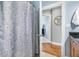 Bathroom featuring a shower with decorative shower curtain, with a doorway into another room in the background at 325 E Paces Ferry Rd # 2003, Atlanta, GA 30305