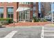 Inviting building entrance with red brick, modern awnings, and well-maintained landscaping at 325 E Paces Ferry Rd # 2003, Atlanta, GA 30305