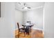Cozy dining area featuring a dark wood table and chairs, illuminated by a modern ceiling fan and hardwood floors at 325 E Paces Ferry Rd # 2003, Atlanta, GA 30305