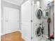Convenient laundry room area with stacked washer and dryer units and adjacent storage and cleaning supplies at 325 E Paces Ferry Rd # 2003, Atlanta, GA 30305