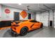 Garage with an orange Corvette and epoxy flooring at 109 Slate Dr, Buford, GA 30518