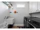 Bright laundry room featuring built-in cabinets and a utility sink at 109 Slate Dr, Buford, GA 30518