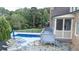 Modern in-ground pool with a large deck and stonework at 109 Slate Dr, Buford, GA 30518