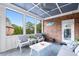 Enjoy this screened porch with brick wall and comfy furniture at 109 Slate Dr, Buford, GA 30518