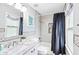 Clean bathroom with a shower/tub combo and granite countertop at 665 Windsor Sw St, Atlanta, GA 30310