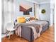 Gray daybed with yellow and patterned pillows in a bedroom with hardwood floors at 665 Windsor Sw St, Atlanta, GA 30310