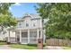 Gray two-story house with white porch and brick mailbox, nicely landscaped at 665 Windsor Sw St, Atlanta, GA 30310