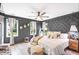 Main bedroom with dark gray walls, king bed, and geometric wall paneling at 665 Windsor Sw St, Atlanta, GA 30310