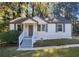 Charming ranch home with white brick exterior, gray shutters, and a welcoming front porch at 1537 N Columbia Pl, Decatur, GA 30032